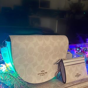 This is a medium sized white crossbody Coach bag and matching wallet.